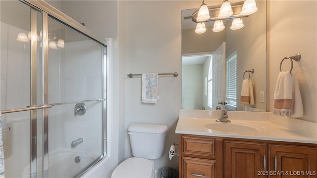 full bathroom featuring shower / bath combination with glass door, vanity, and toilet