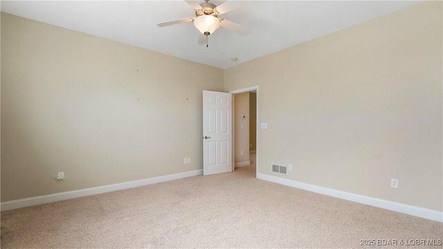 4906 Wilson Dr, Osage Beach, MO 65065 - spare room featuring baseboards, visible vents, a ceiling fan, and light colored carpet