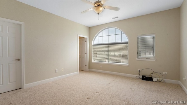 carpeted empty room featuring ceiling fan