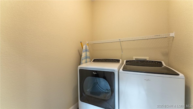 clothes washing area with washing machine and clothes dryer