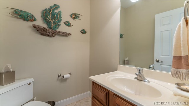 4906 Wilson Dr, Osage Beach, MO 65065 - half bathroom featuring toilet, baseboards, and vanity