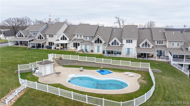 view of pool featuring a shed, a yard, and a patio