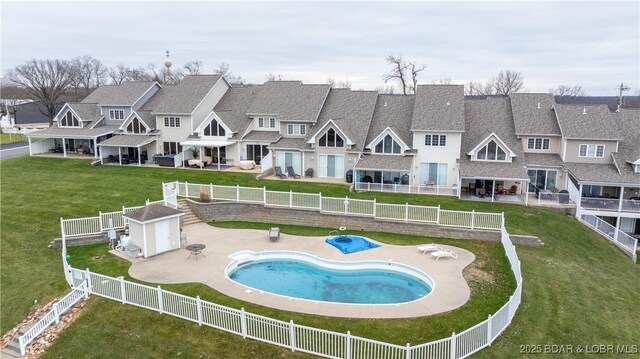 view of swimming pool featuring a shed, a lawn, and a patio