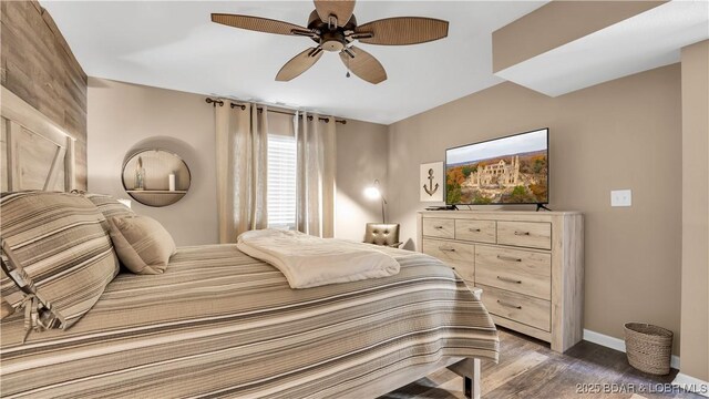 bedroom with dark wood-type flooring and ceiling fan