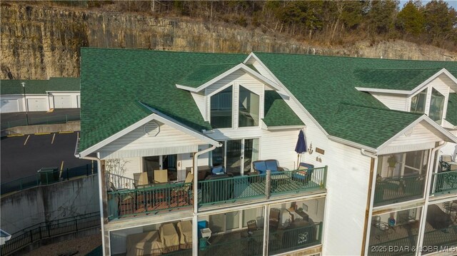 rear view of property with a balcony