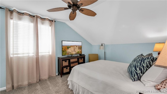 carpeted bedroom featuring baseboards, ceiling fan, and vaulted ceiling