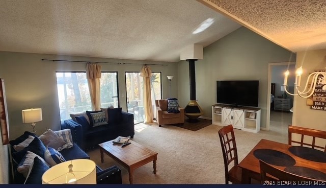 carpeted living room featuring vaulted ceiling, a textured ceiling, and a wood stove