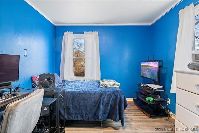 bedroom with ornamental molding and wood-type flooring