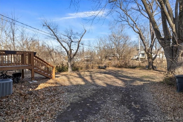 view of yard with a wooden deck and cooling unit