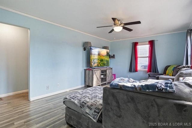 bedroom with wood-type flooring, ornamental molding, and ceiling fan