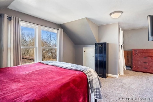 carpeted bedroom featuring lofted ceiling