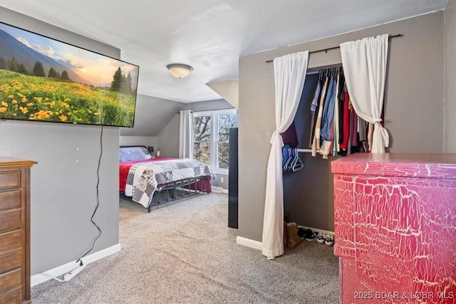 bedroom with carpet floors and vaulted ceiling