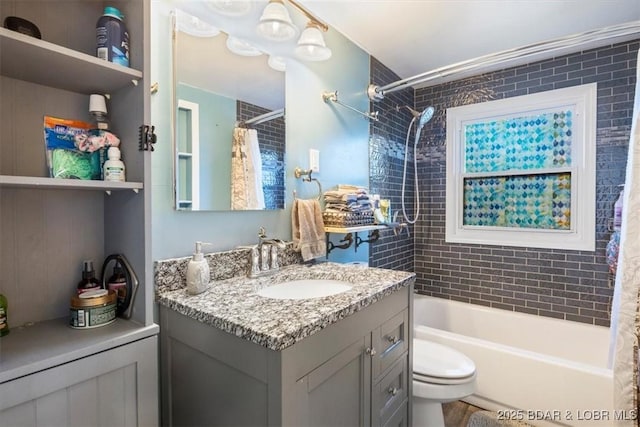 full bathroom featuring vanity, shower / bath combo, and toilet