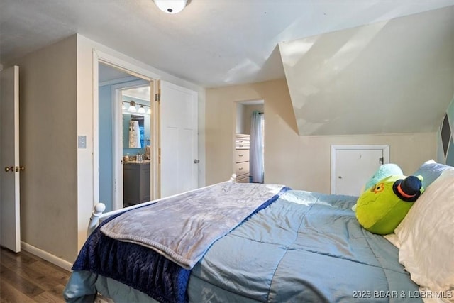 bedroom with wood-type flooring and vaulted ceiling