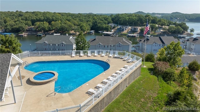 view of swimming pool with a community hot tub, a patio, and a water view