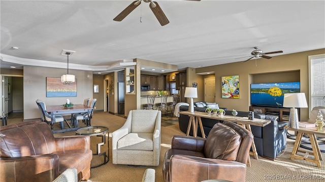 carpeted living room featuring ceiling fan