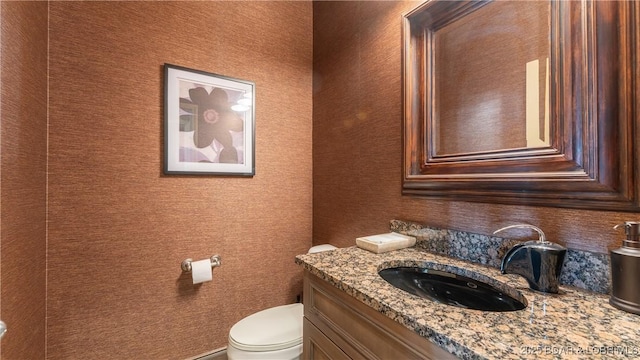 bathroom featuring vanity and toilet