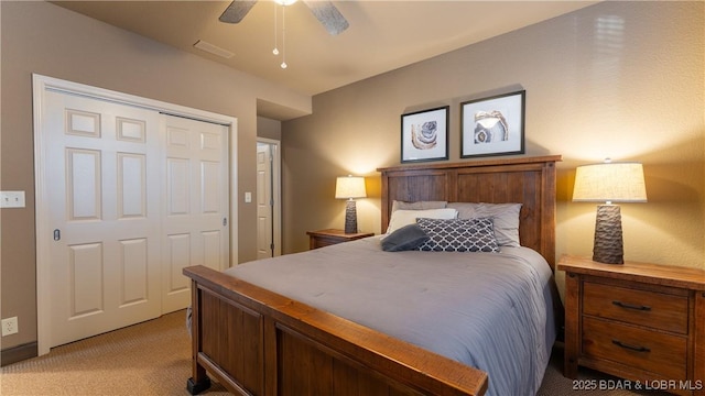 carpeted bedroom with ceiling fan and a closet