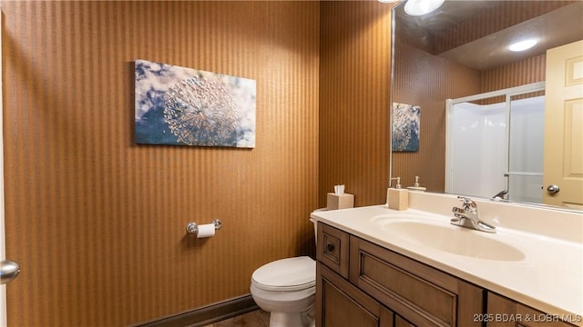 bathroom with vanity, an enclosed shower, and toilet