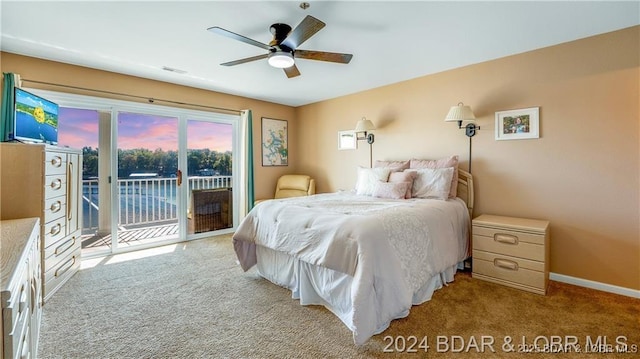 bedroom with light carpet, access to outside, and ceiling fan