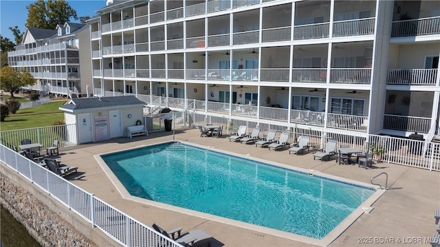 community pool with ceiling fan, a patio, and fence