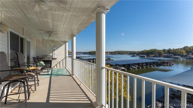 balcony with a water view and ceiling fan