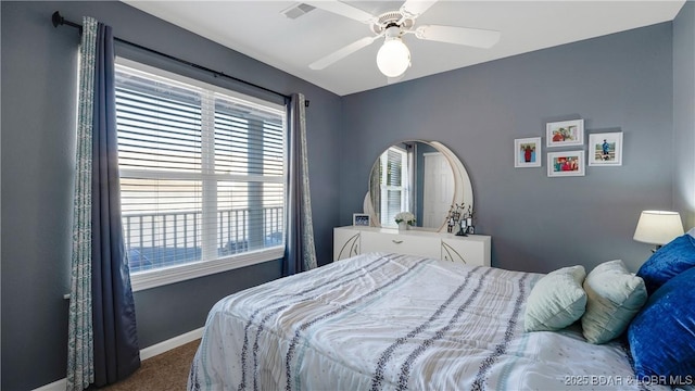 bedroom with visible vents, baseboards, ceiling fan, and carpet flooring