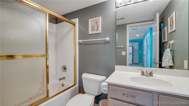 full bathroom featuring visible vents, toilet, combined bath / shower with glass door, a textured ceiling, and vanity