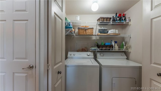 clothes washing area featuring washer and clothes dryer and laundry area