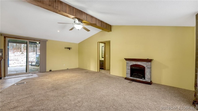 unfurnished living room with light carpet, vaulted ceiling with beams, a fireplace, and ceiling fan