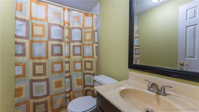 bathroom with vanity, a shower with shower curtain, and toilet