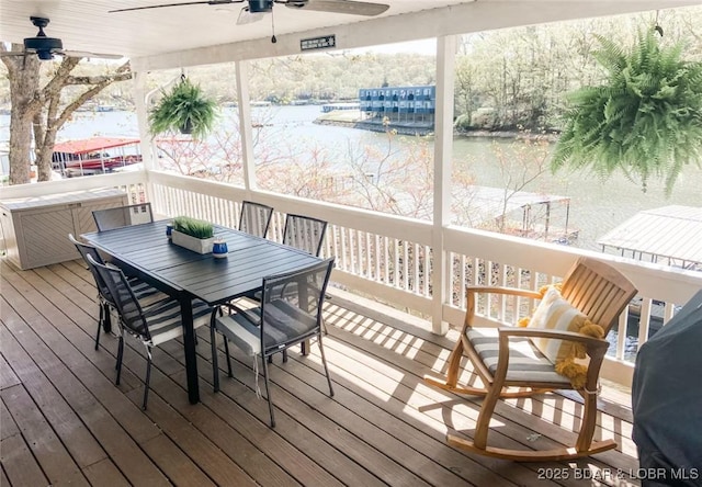 wooden terrace featuring a water view and ceiling fan