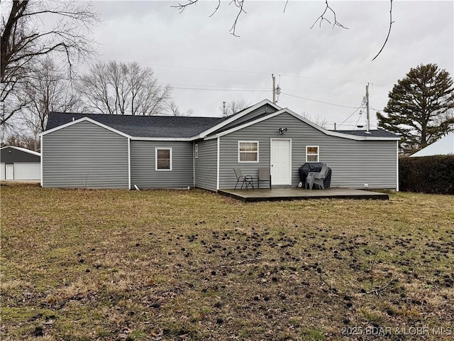 back of property featuring a lawn and a patio