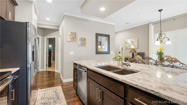 kitchen featuring dark wood-style flooring, a sink, ornamental molding, stainless steel appliances, and dark brown cabinets