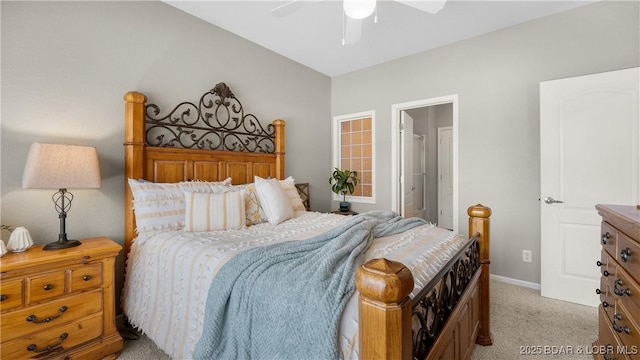 bedroom with a ceiling fan, light colored carpet, and baseboards