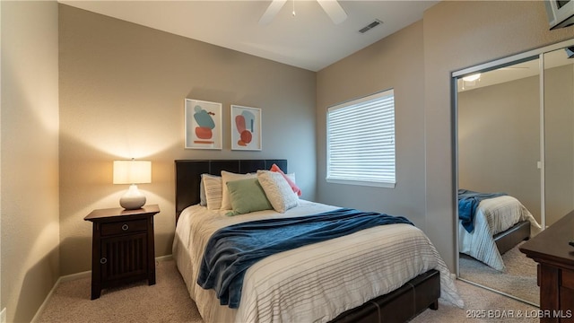 bedroom with light carpet, visible vents, baseboards, and ceiling fan