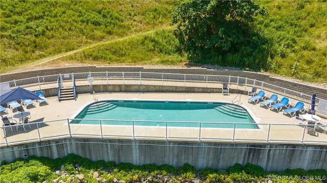 pool featuring a patio and fence