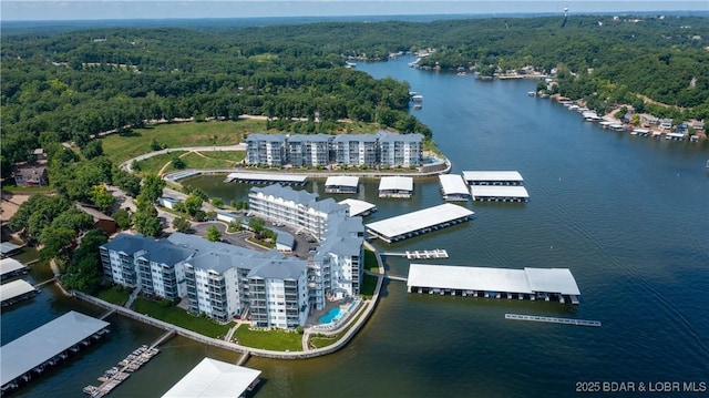 aerial view with a wooded view and a water view