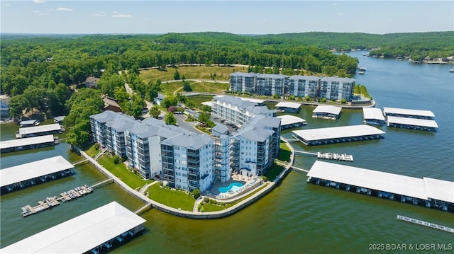 drone / aerial view with a view of trees and a water view