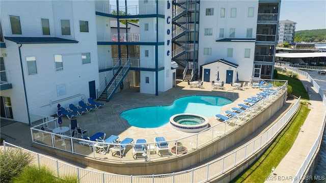 community pool with a patio area, a community hot tub, and stairs