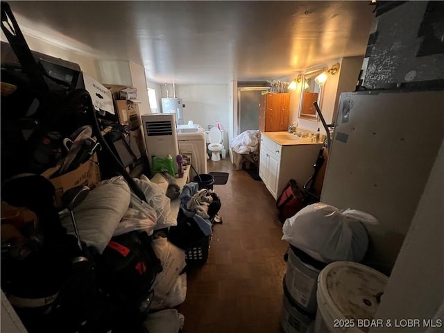 interior space with washer / clothes dryer, sink, and water heater