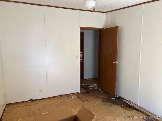 unfurnished room featuring a textured ceiling