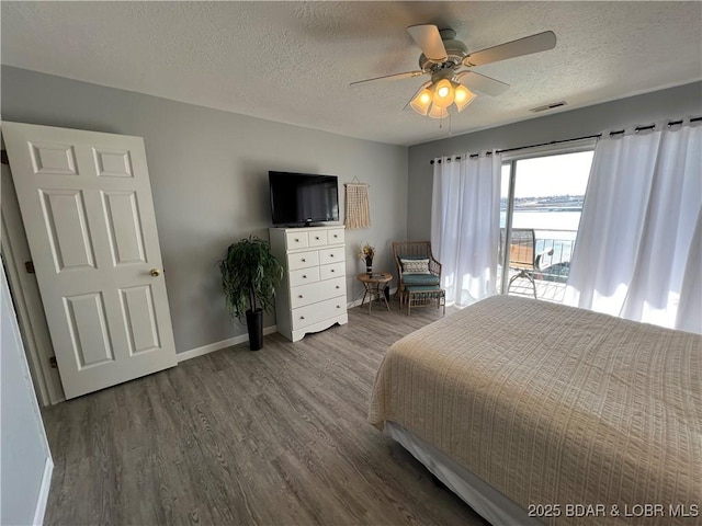 bedroom featuring hardwood / wood-style flooring, ceiling fan, and a textured ceiling