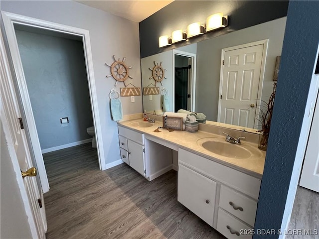 bathroom with vanity, hardwood / wood-style flooring, and toilet