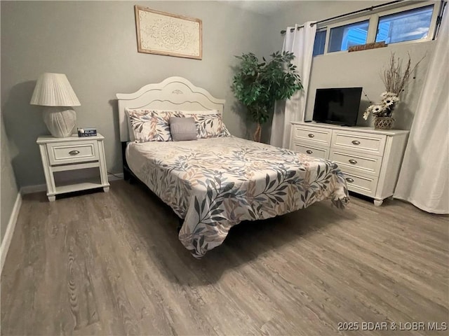 bedroom with dark hardwood / wood-style floors