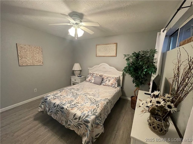 bedroom featuring ceiling fan, dark hardwood / wood-style flooring, and a textured ceiling