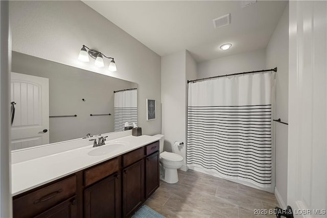 bathroom with vanity, toilet, and a shower with shower curtain