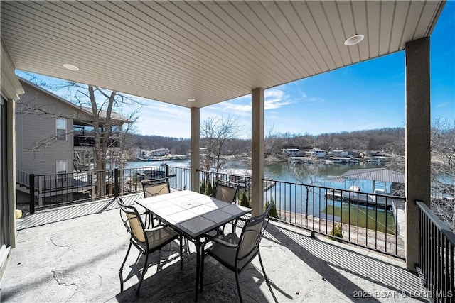 view of patio / terrace featuring a water view and a balcony