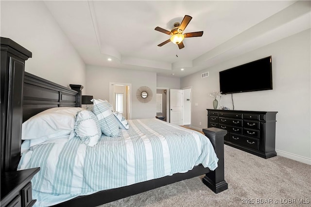 bedroom featuring a raised ceiling, carpet floors, and ceiling fan