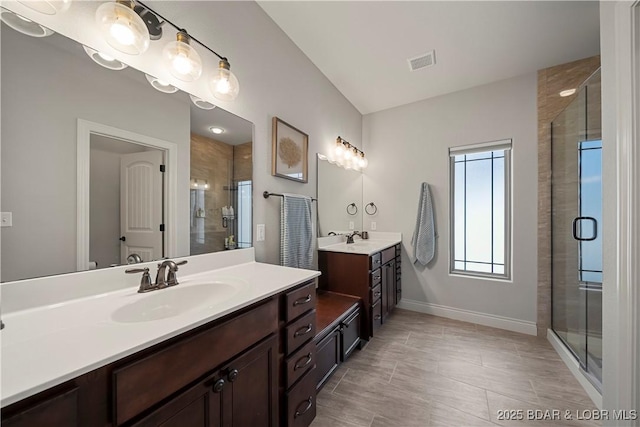 bathroom with vanity and an enclosed shower